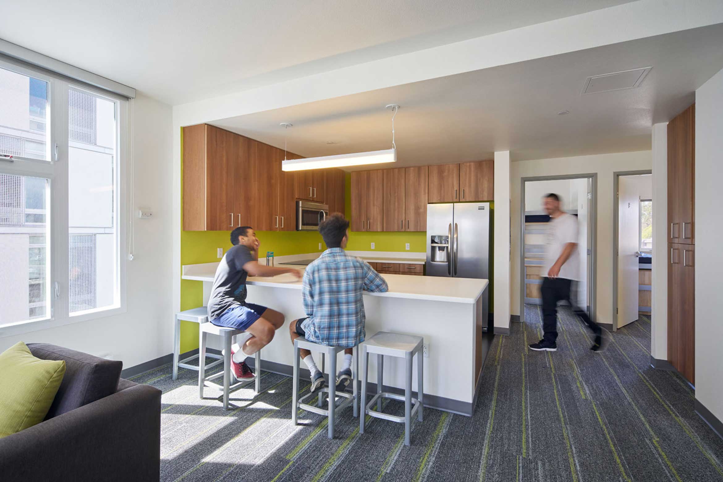 ucsb students sitting in the kitchen area at Sierra Madre apartment
