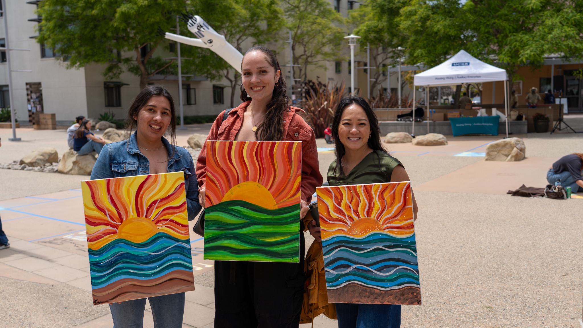 Staff with paintings in front of chalk festival