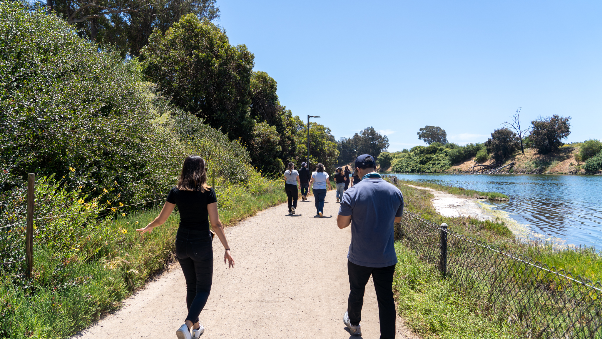 staff walking along the lagoon