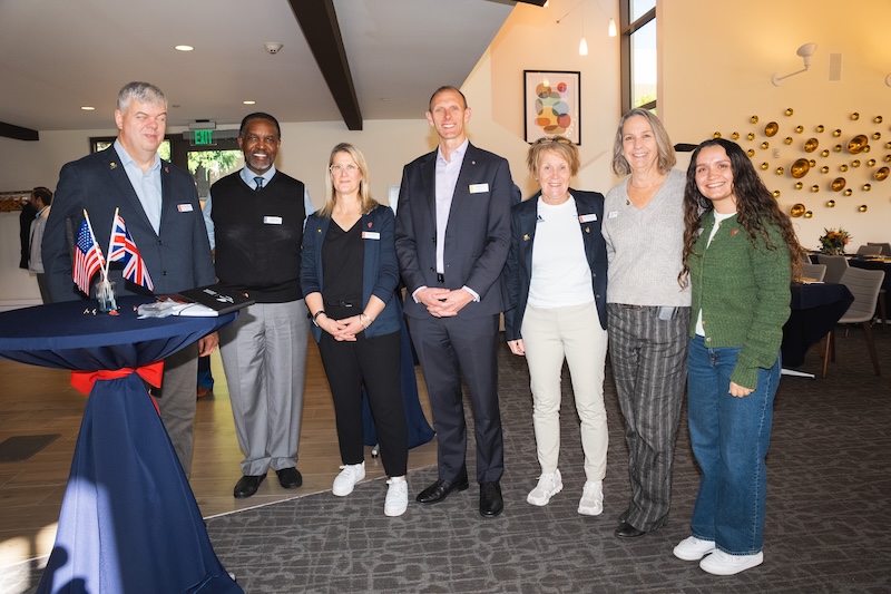 eight people standing at the club and guest house