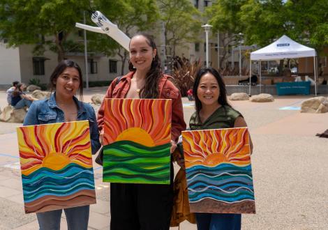 Staff with paintings in front of chalk festival