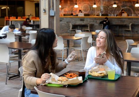 Student enjoying burgers.