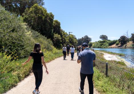 staff walking along the lagoon