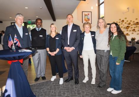 eight people standing at the club and guest house