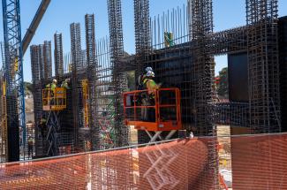 two construction workers on the facade of a building