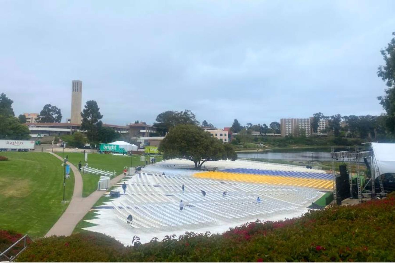 view overlooking employees and student workers setting up thousands of chairs for commencement