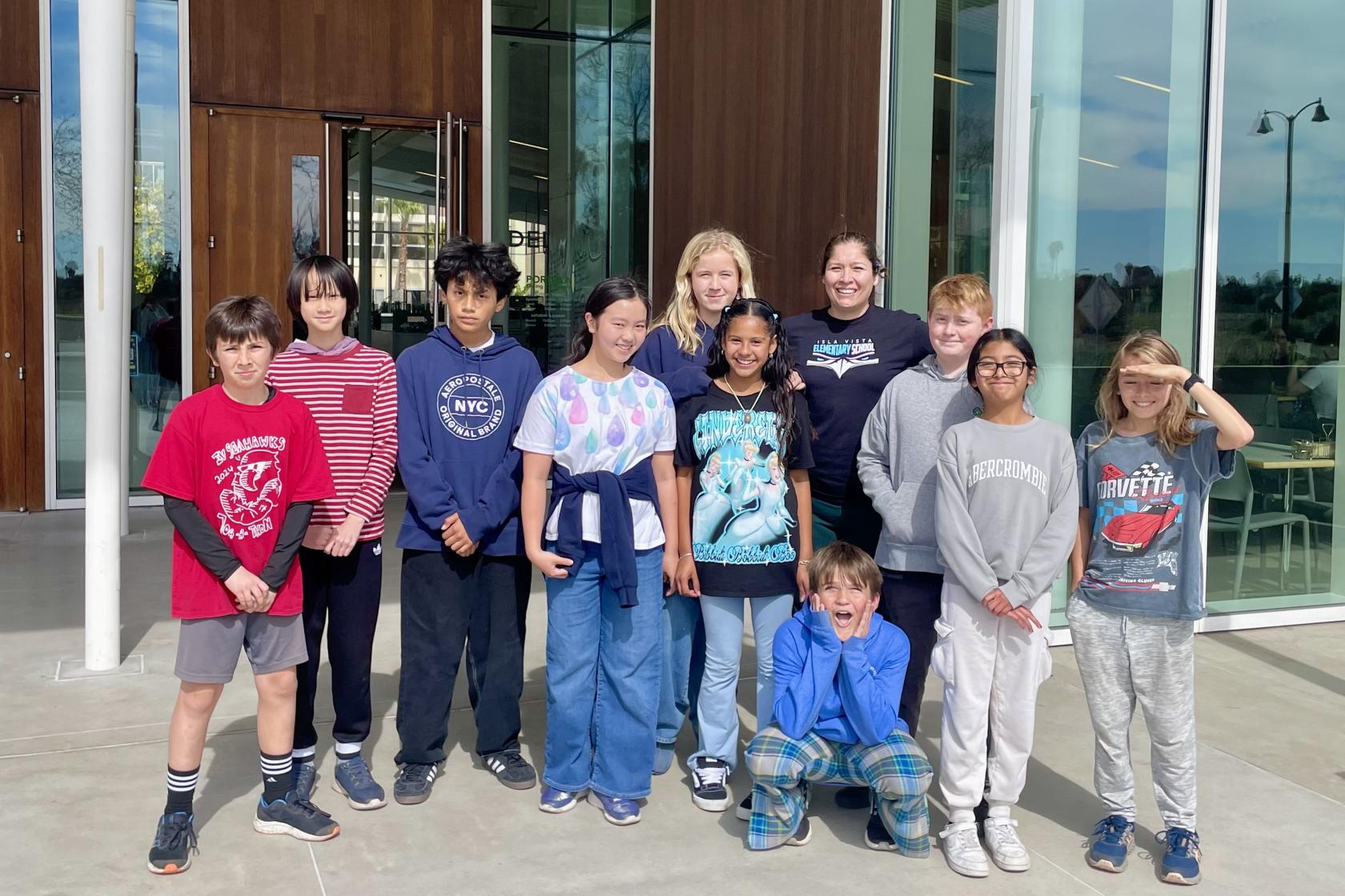 A group of sixth graders pose outside Portola Dining Commons