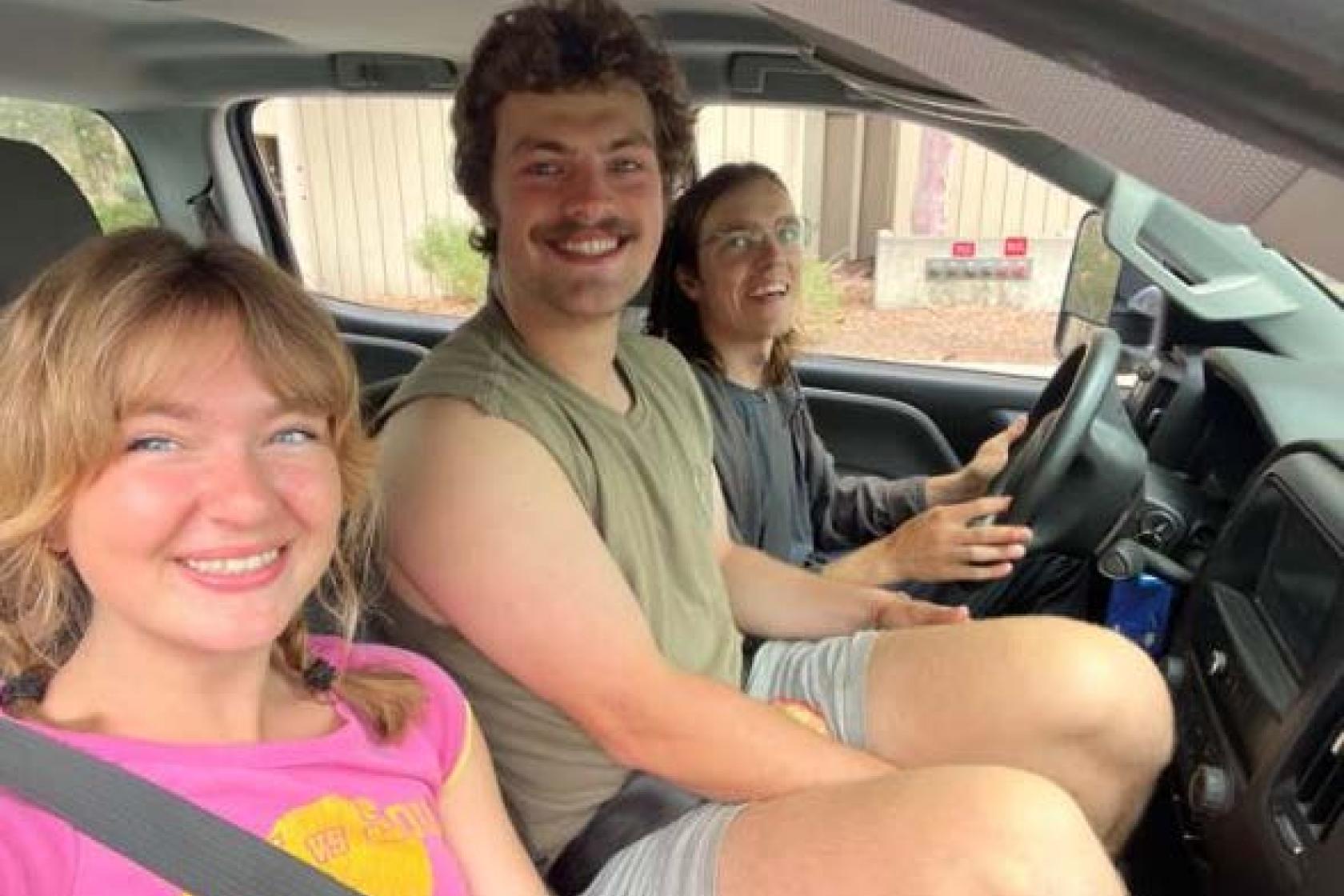 graduate students in a car