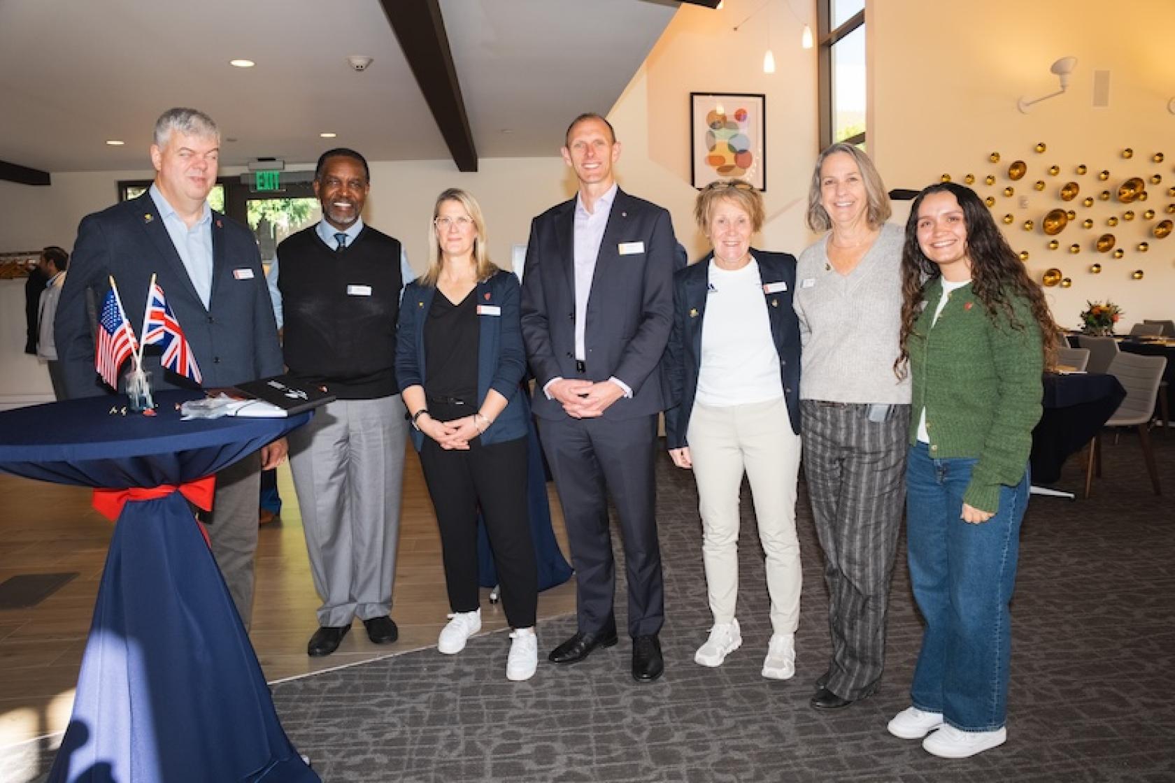 eight people standing at the club and guest house