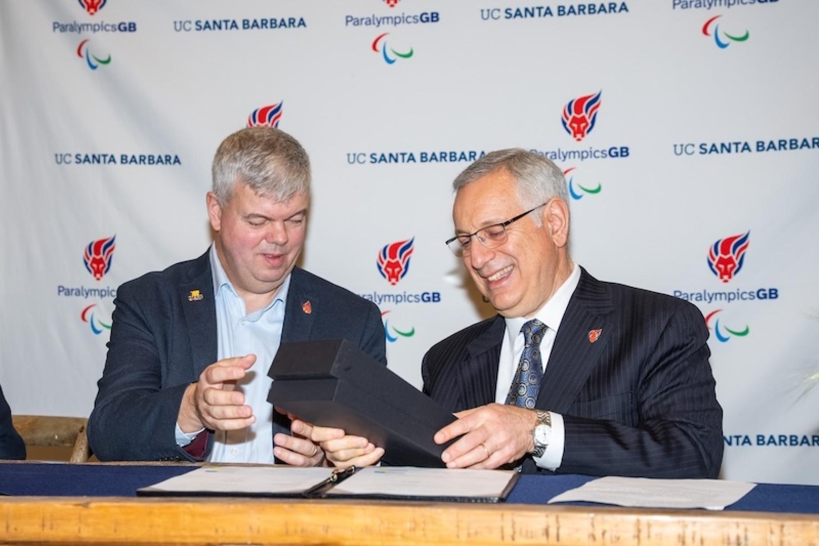 two men looking at award