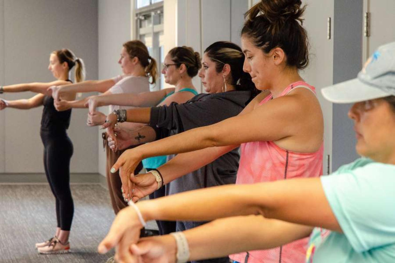 UCSB employees stretching during a work out class